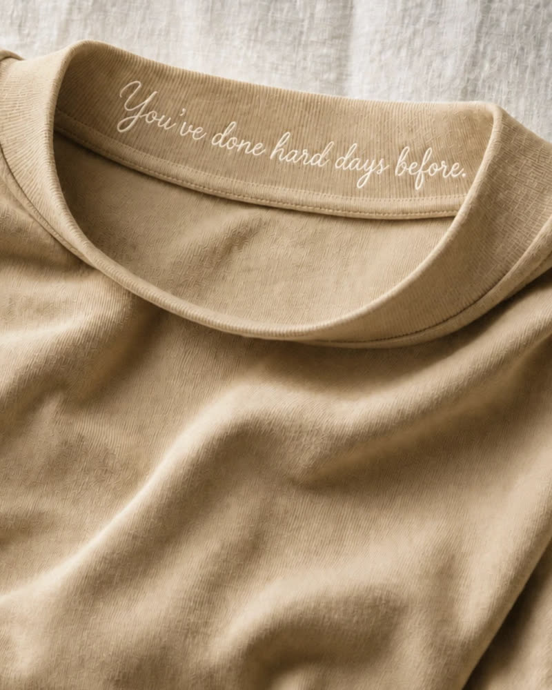 A visualisation of the embroidered collar message on the sand colourway